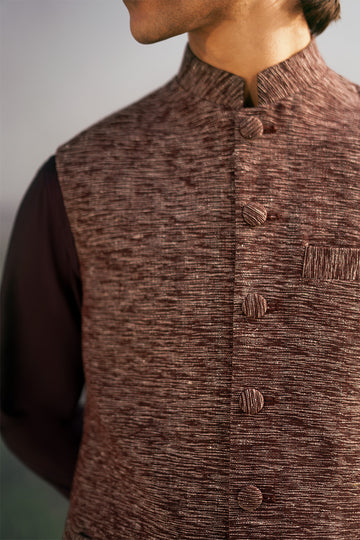 Traditional waistcoat design for men in Pakistan, featuring a sleek maroon finish. Ideal for weddings and festive occasions.